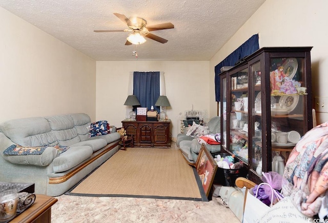 living room with ceiling fan, light colored carpet, and a textured ceiling