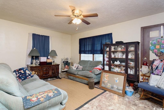 living room featuring ceiling fan and a textured ceiling