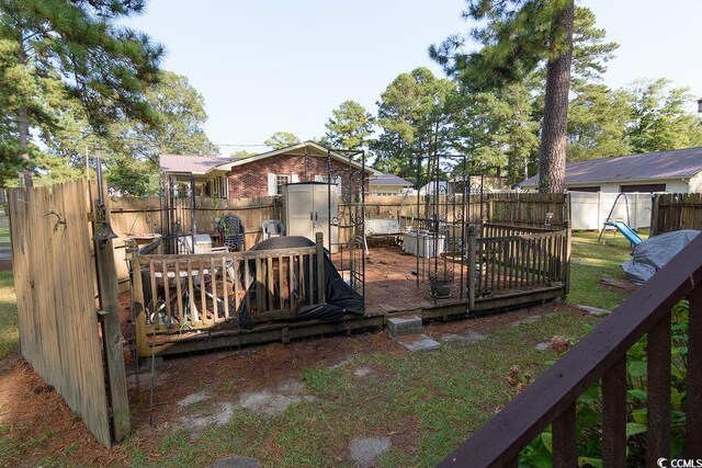 wooden terrace featuring a yard