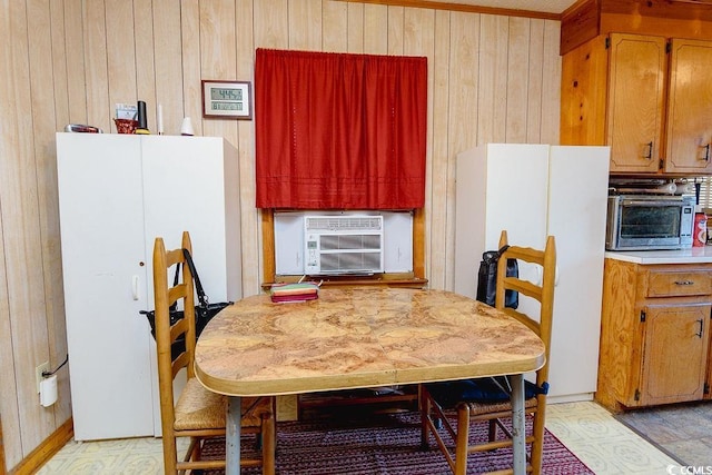 dining space with cooling unit and wood walls