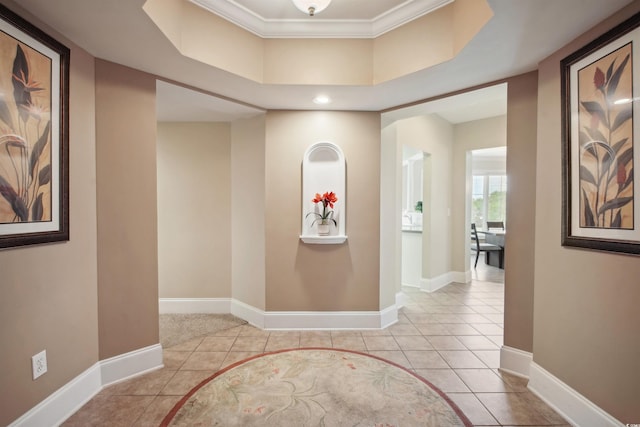 hall with crown molding and light tile patterned flooring