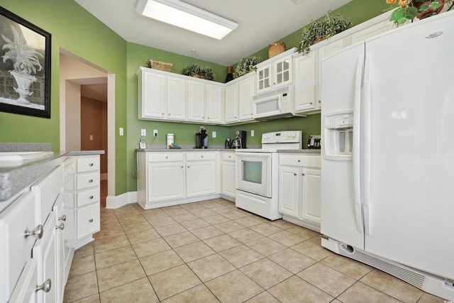 kitchen featuring white cabinets, white appliances, and light tile patterned flooring