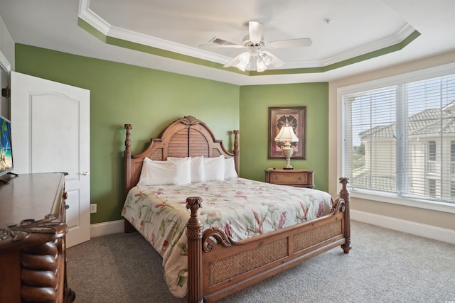 carpeted bedroom with crown molding, a raised ceiling, and ceiling fan