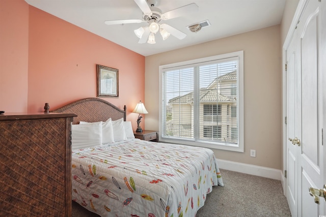 bedroom with ceiling fan and light carpet