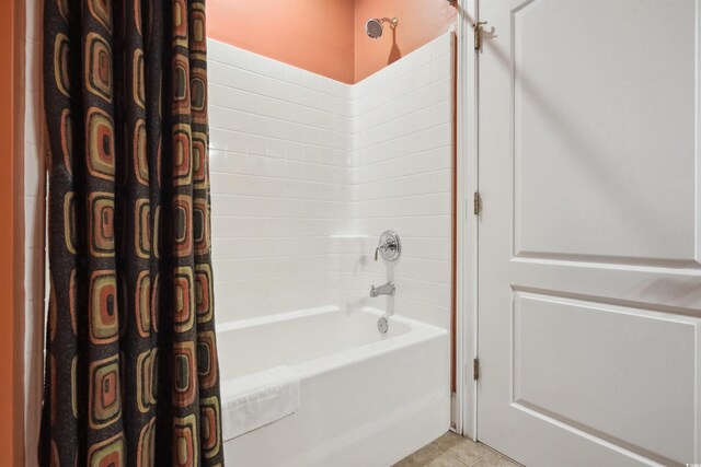 bathroom with shower / bath combination with curtain and tile patterned flooring