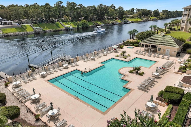 view of swimming pool featuring a water view, a patio area, and a gazebo