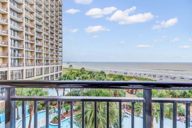 balcony with a beach view and a water view