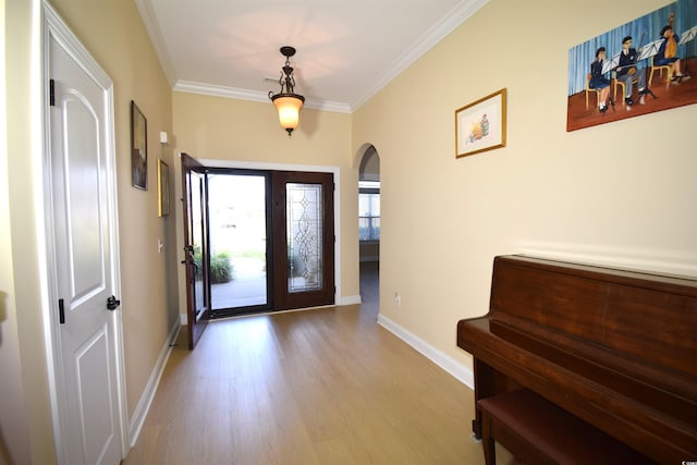 foyer featuring light hardwood / wood-style flooring and crown molding