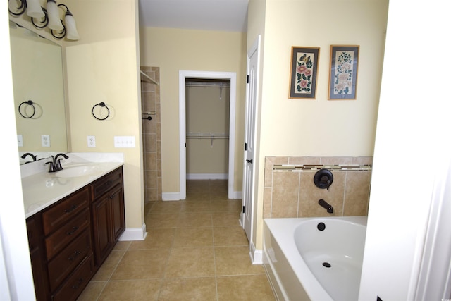 bathroom featuring tile patterned floors, a tub, and toilet