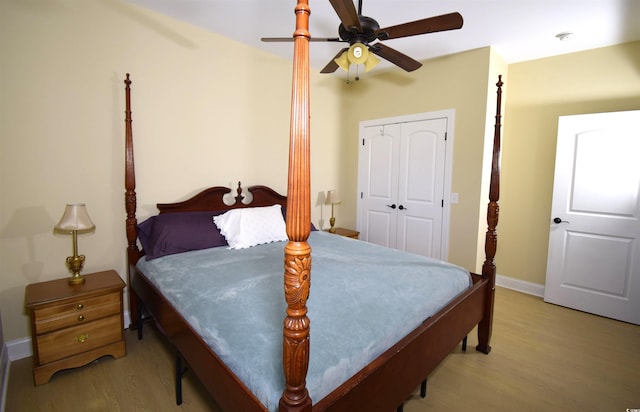 bedroom featuring ceiling fan, a closet, and light hardwood / wood-style floors