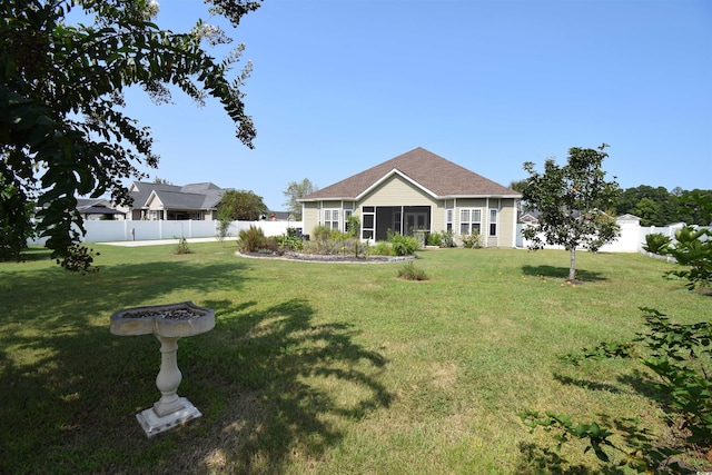 view of front of home with a sunroom and a front yard