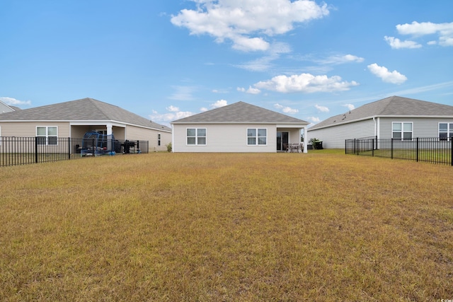 back of property featuring a yard