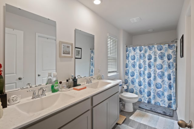 bathroom with vanity, toilet, a shower with curtain, and hardwood / wood-style floors