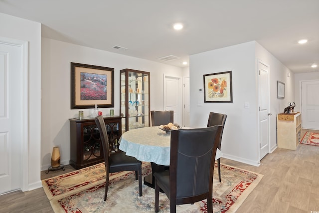 dining space with light wood-type flooring