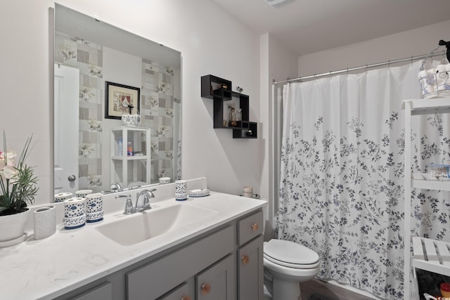 bathroom featuring walk in shower, vanity, toilet, and hardwood / wood-style floors