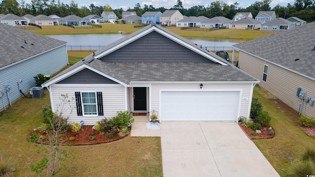 view of front of property with a garage, central AC unit, and a front lawn