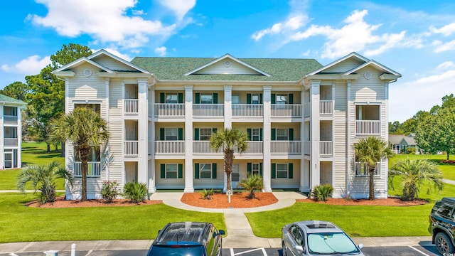 exterior space with a lawn and a balcony