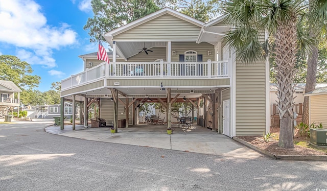 coastal home featuring central AC, a carport, and ceiling fan