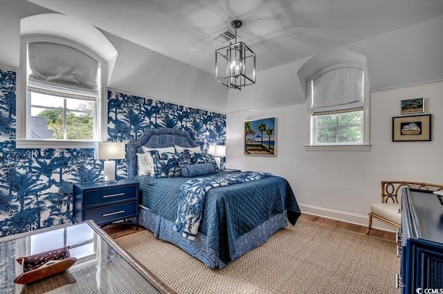 bedroom with a notable chandelier and wood-type flooring