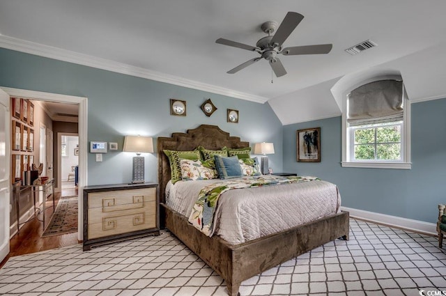 bedroom featuring ornamental molding, vaulted ceiling, hardwood / wood-style flooring, and ceiling fan