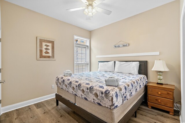 bedroom with wood-type flooring and ceiling fan