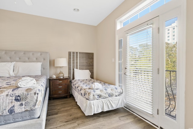 bedroom featuring hardwood / wood-style flooring and access to outside