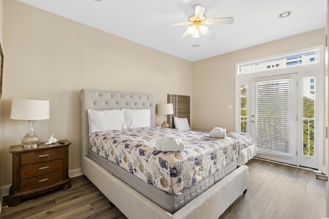 bedroom with dark hardwood / wood-style flooring, access to outside, and ceiling fan