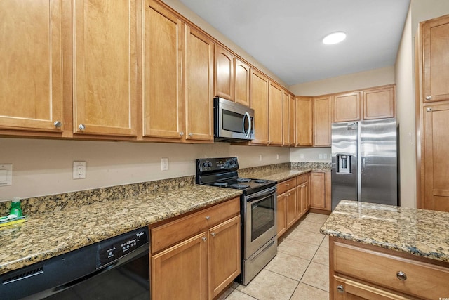 kitchen with light stone counters, appliances with stainless steel finishes, and light tile patterned floors