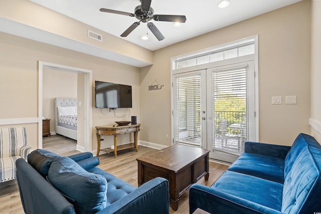 living room with ceiling fan, light hardwood / wood-style floors, and french doors