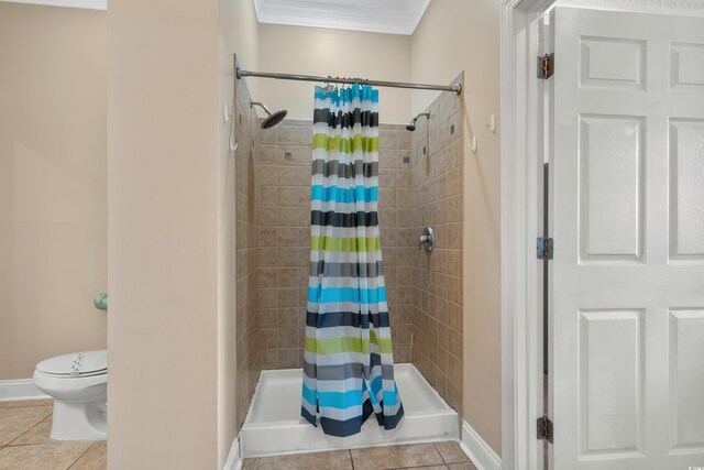 bathroom featuring walk in shower, toilet, tile patterned flooring, and crown molding