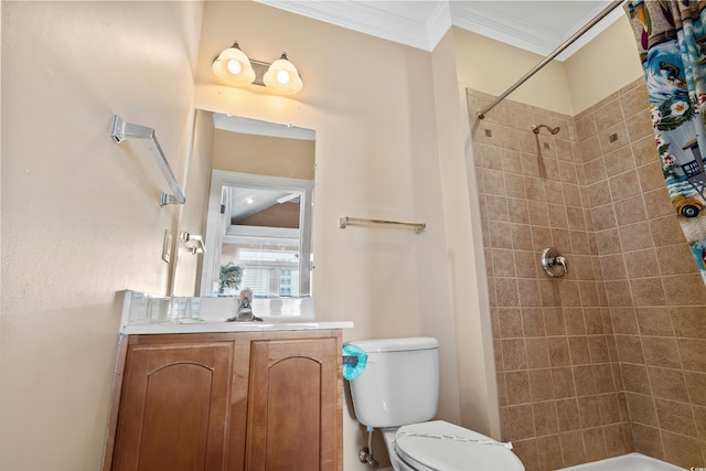 bathroom featuring vanity, crown molding, toilet, and a tile shower