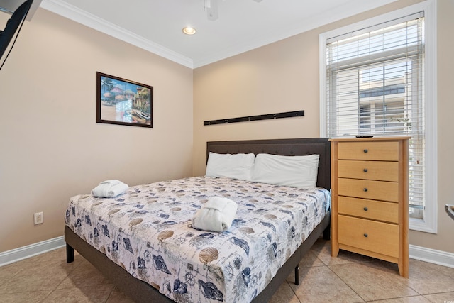 bedroom with ornamental molding and light tile patterned floors