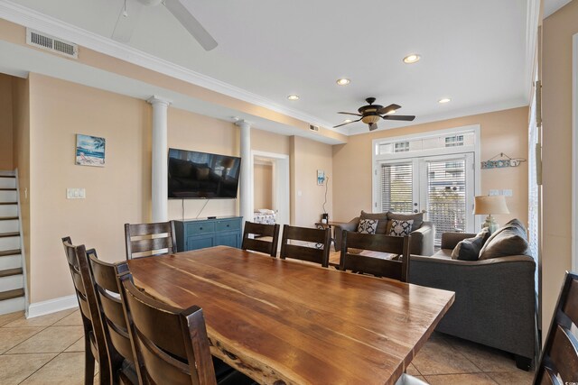 dining area featuring light tile patterned floors, crown molding, decorative columns, and ceiling fan