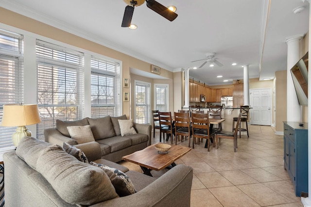 living room featuring crown molding, ceiling fan, decorative columns, and light tile patterned floors