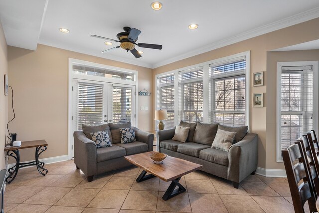 living room with light tile patterned flooring, ornamental molding, a wealth of natural light, and french doors