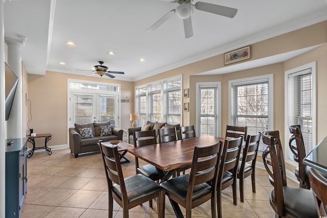 dining space with ornamental molding, plenty of natural light, and light tile patterned floors