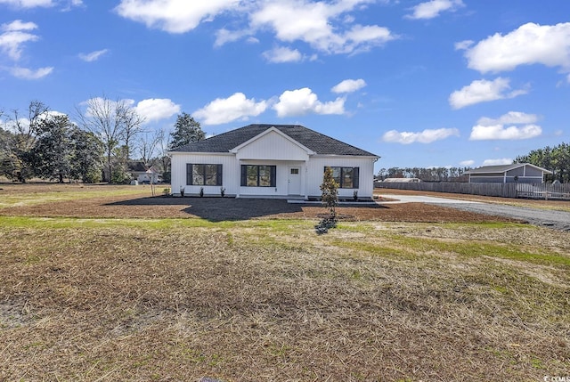 modern farmhouse style home with a front yard