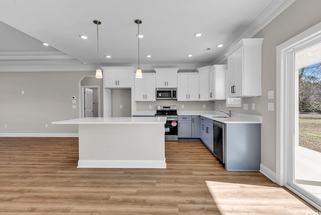 kitchen featuring recessed lighting, stainless steel appliances, white cabinets, and crown molding