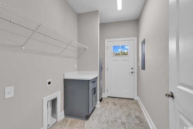 clothes washing area with laundry area, hookup for an electric dryer, and baseboards