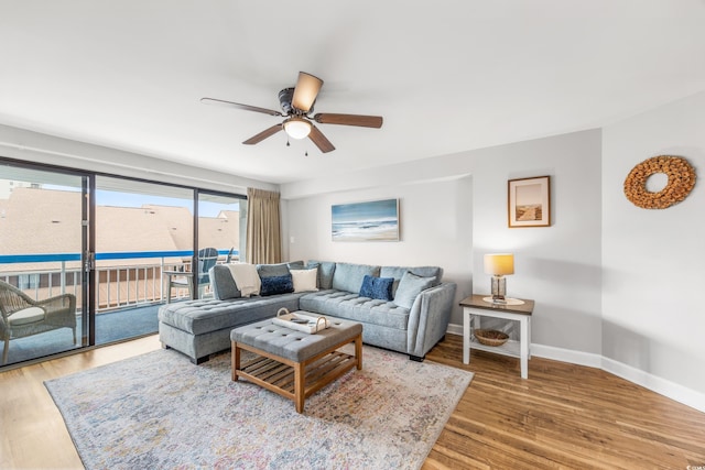 living room featuring ceiling fan and hardwood / wood-style floors