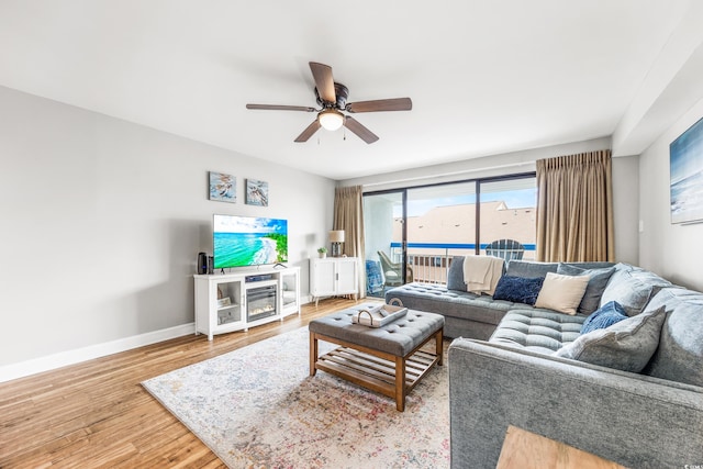 living room with hardwood / wood-style floors and ceiling fan