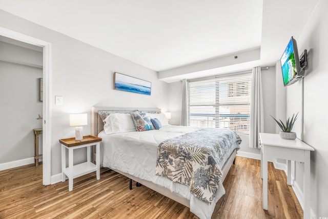 bedroom with hardwood / wood-style floors