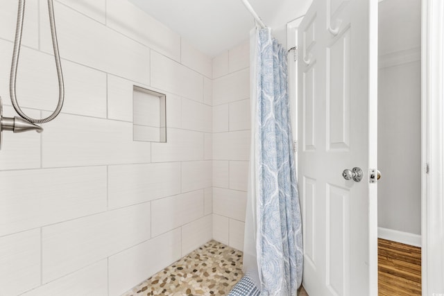 bathroom featuring walk in shower and hardwood / wood-style flooring