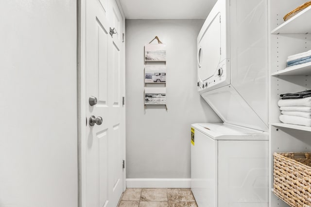 clothes washing area with stacked washer / dryer