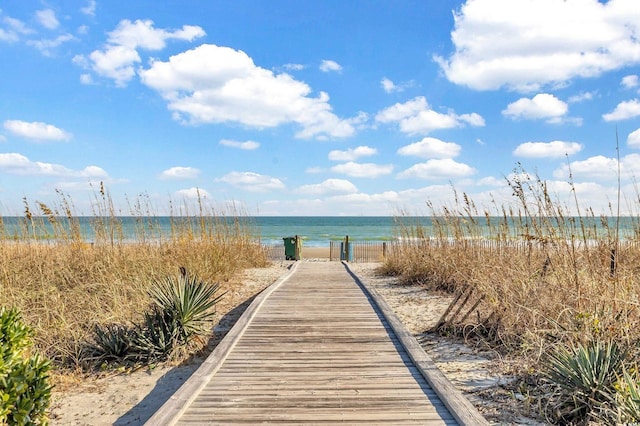 view of home's community featuring a beach view and a water view