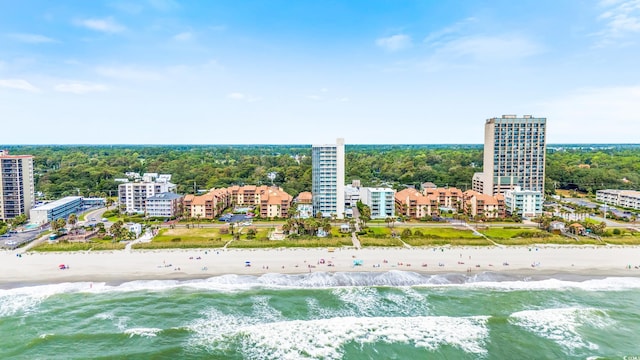 birds eye view of property with a water view and a view of the beach