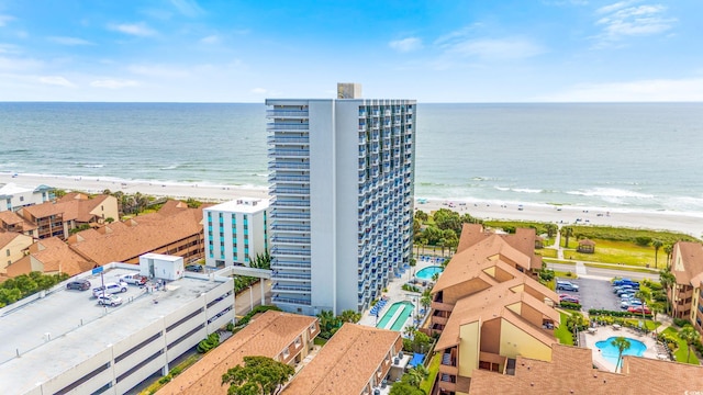 birds eye view of property featuring a view of the beach and a water view