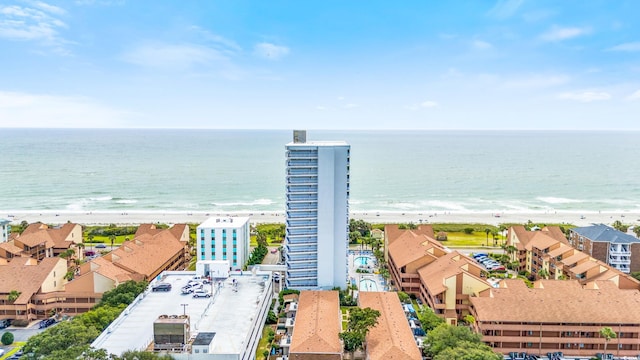 birds eye view of property with a beach view and a water view