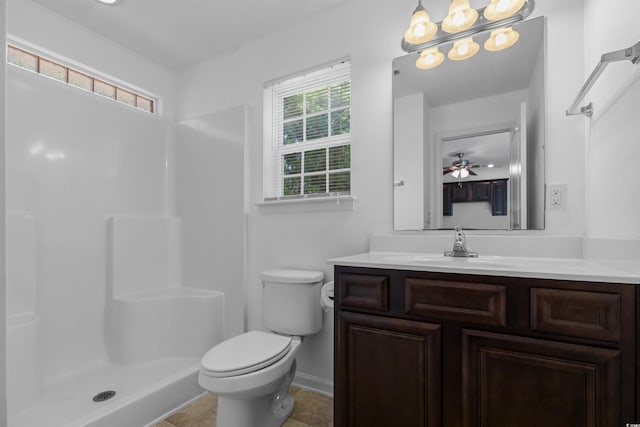 bathroom featuring toilet, tile patterned floors, vanity, a shower, and ceiling fan