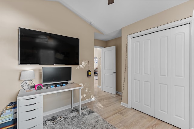 office with lofted ceiling and light hardwood / wood-style flooring